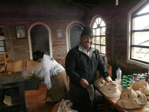 In addition to running a hostel, the owner of this establishment makes and sells wooden masks.  In the back you can see him wife tending to the wood-burning stove.